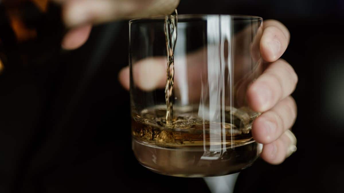 A drink being poured into a glass