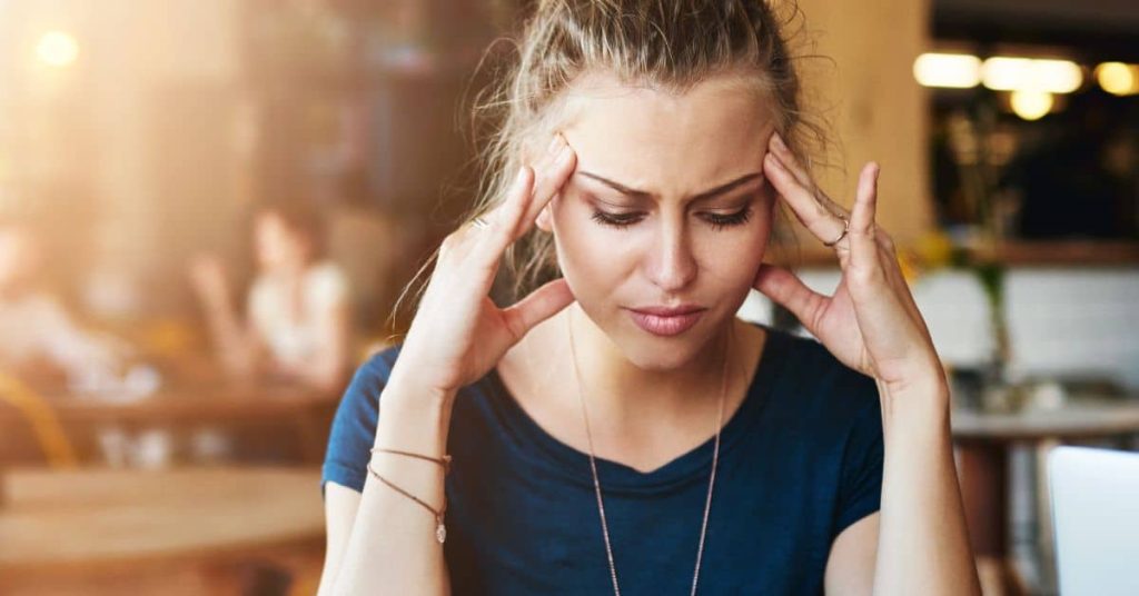 Stressed woman holding head