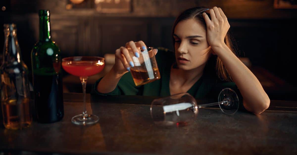 Woman at a bar holding a drink